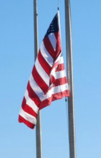 American flag flying at golf tournament