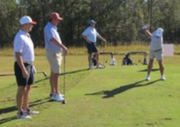 Golfers on the driving range at the tournament