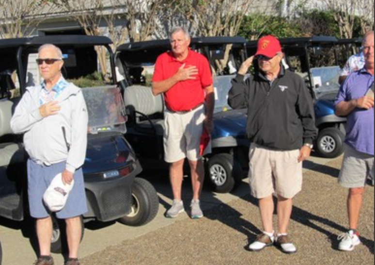Golfers with hands over hearts during pledge