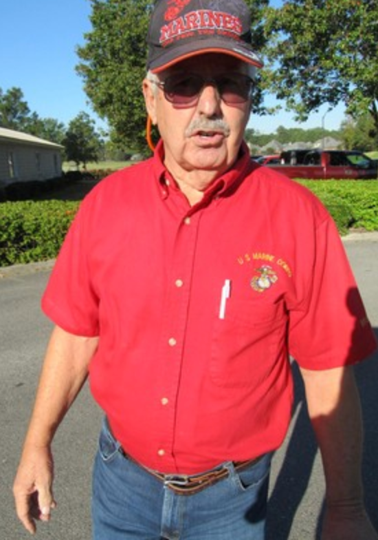 Marine in red U.S. Marine Corps shirt and Marines cap