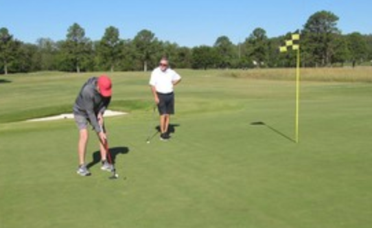 Golfer putting on the green at Bent Brook Golf Course