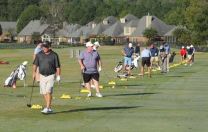 Golfers warming up on the driving range
