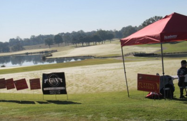 Sponsor tent and putting contest signage on the course