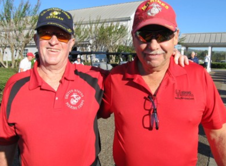 Two Marines smiling together at the golf tournament