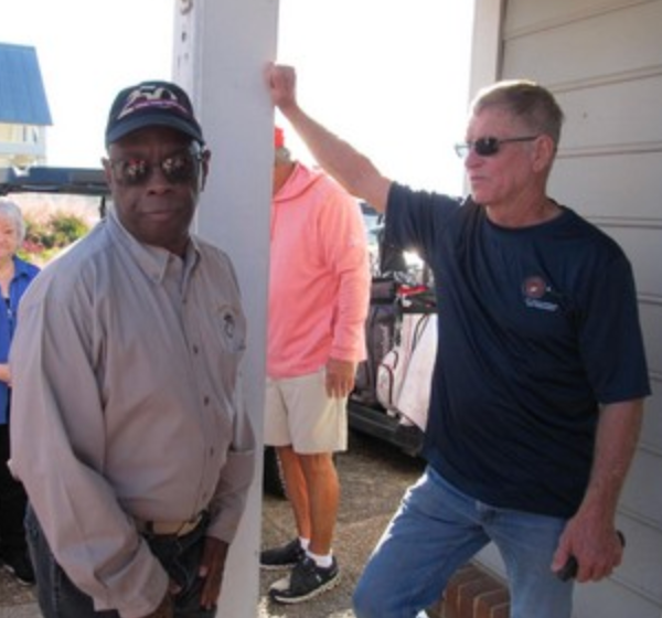 Two men standing together at the golf tournament