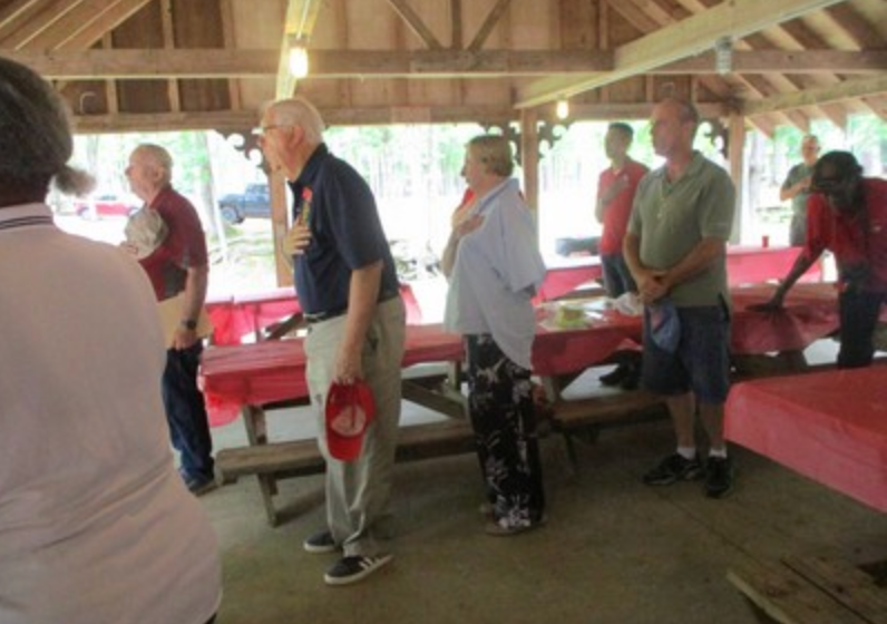 Members standing at attention in pavilion