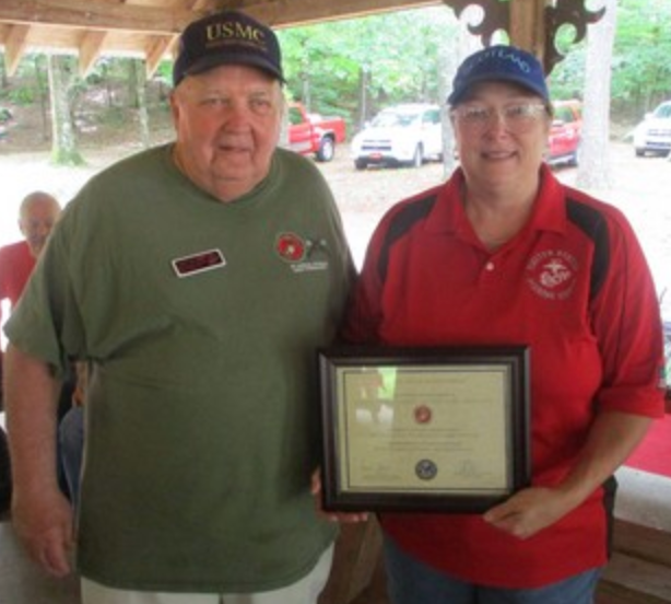 Two members holding framed certificate