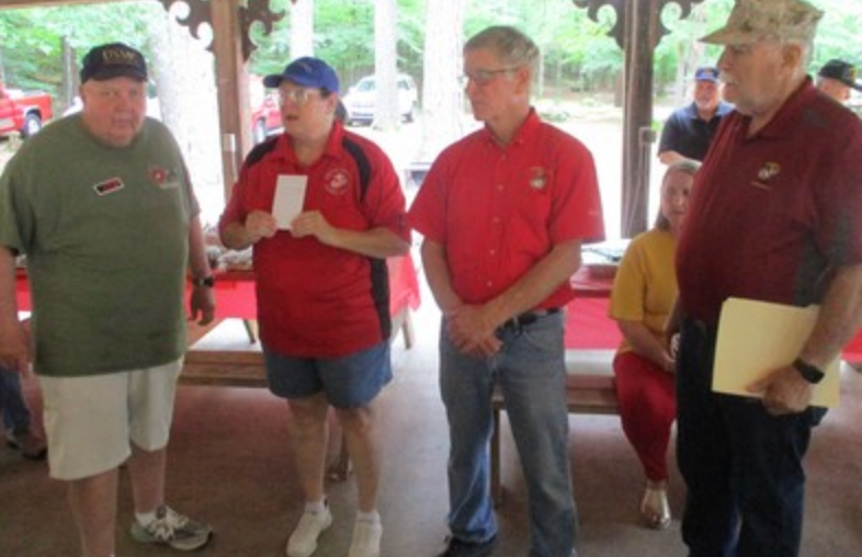Four members standing in pavilion
