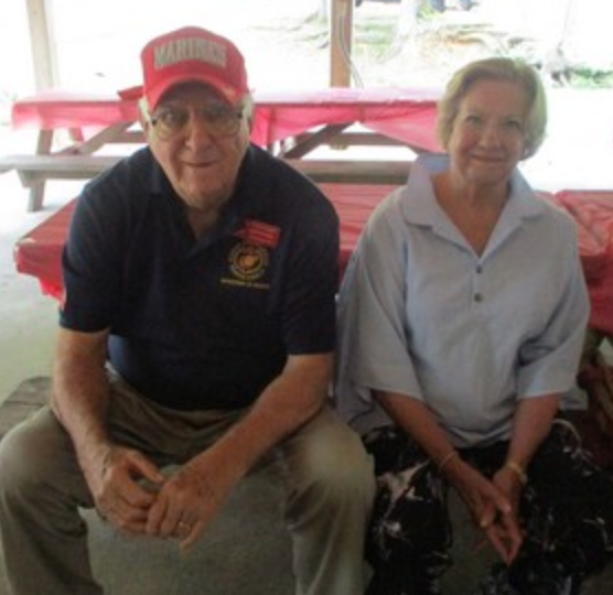 Two members seated at outdoor event