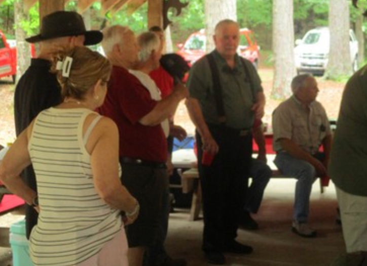 Group of members gathered under pavilion