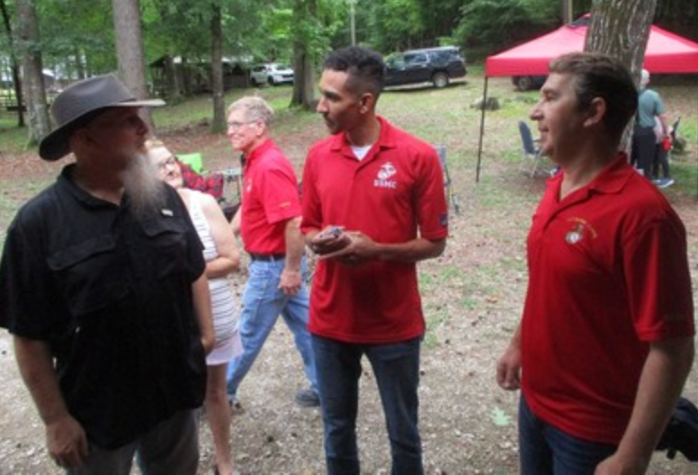 Members in USMC shirts conversing outdoors