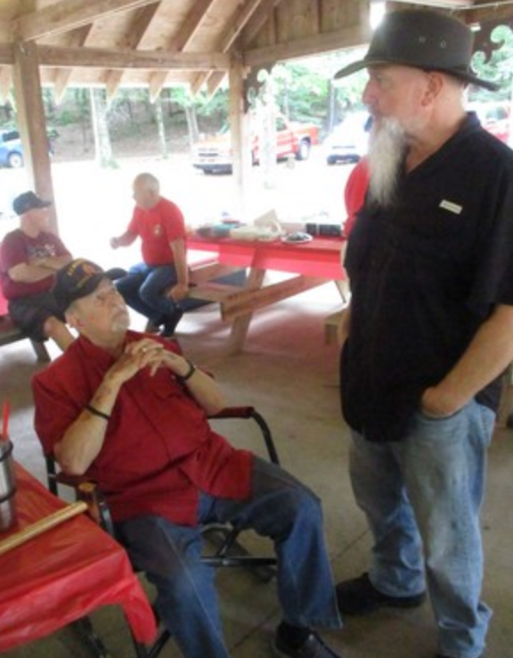 Members chatting under pavilion