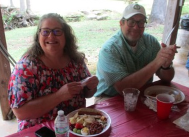 Couple smiling at table with food