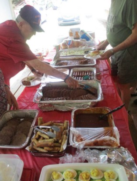 Member serving ribs at the buffet table