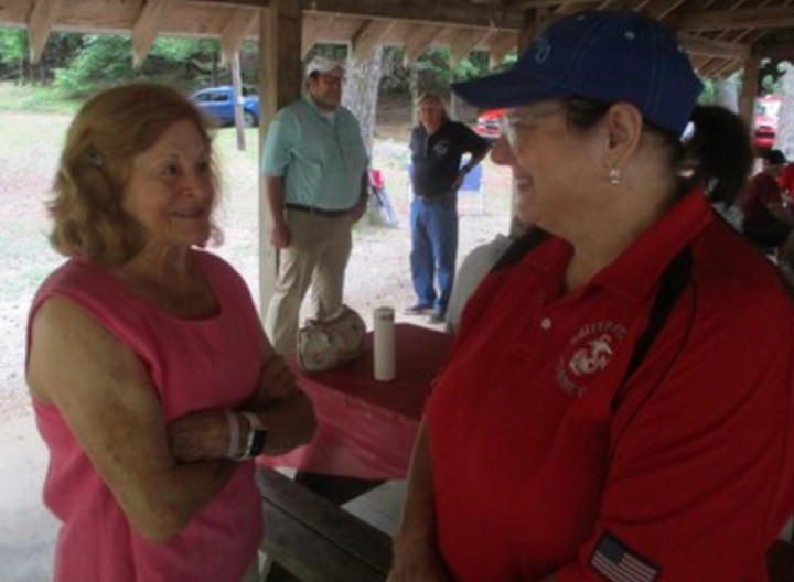 Members conversing at outdoor event