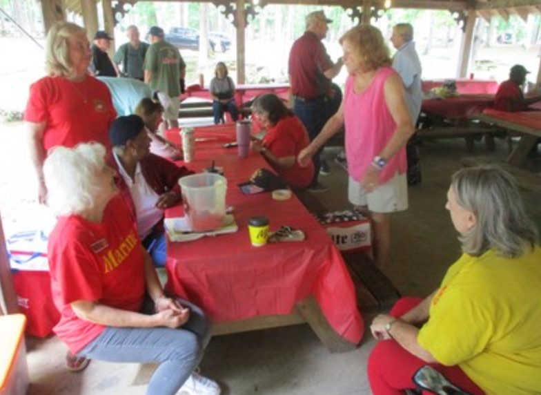 Members in red Marine Corps shirts outdoors