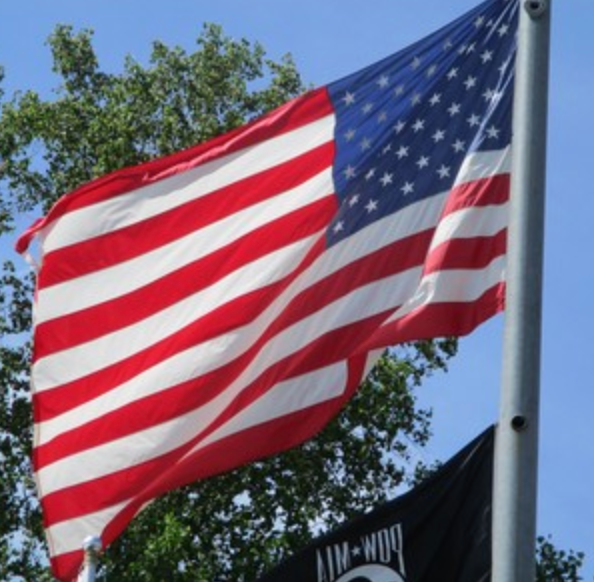 American flag and POW-MIA flag flying outdoors