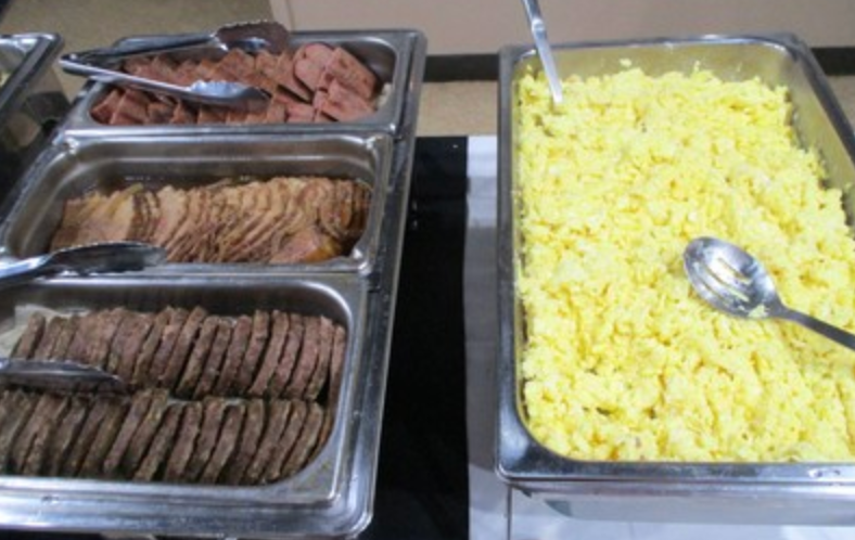 Breakfast buffet trays with sausage and scrambled eggs