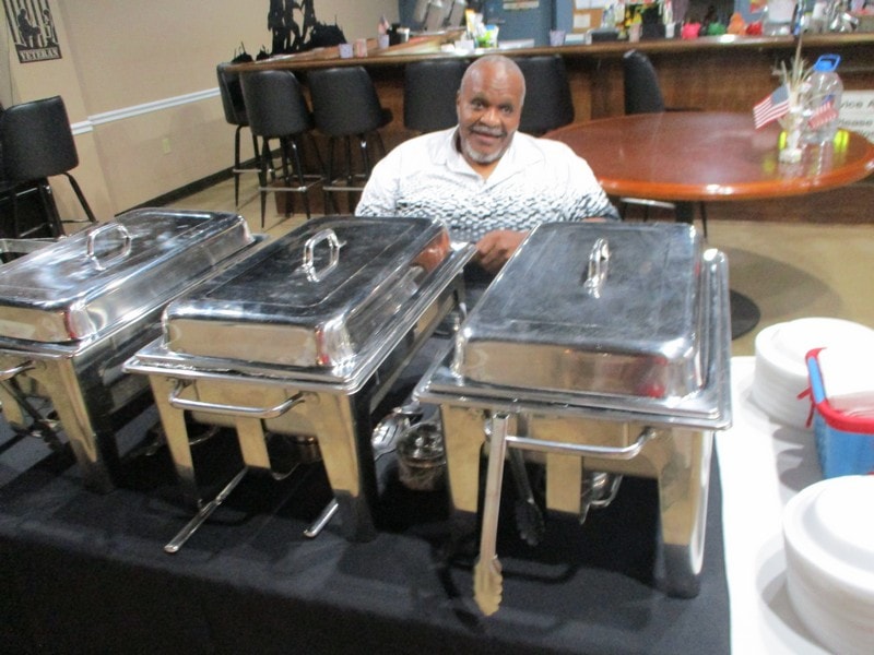 Member posing with catering chafing dishes