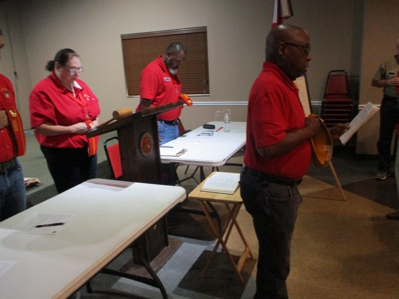 Members in red shirts at community meeting