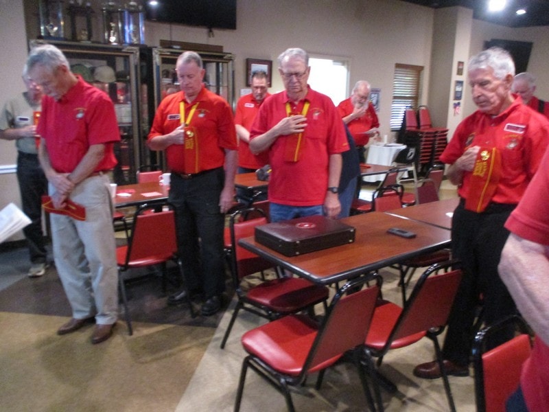Group of volunteers in red shirts meeting indoors