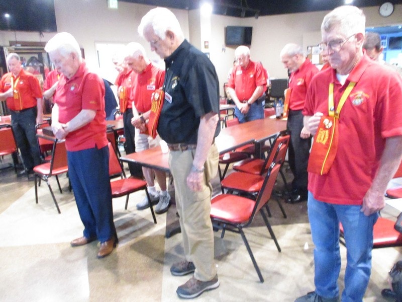 Senior members gathering indoors wearing red uniforms