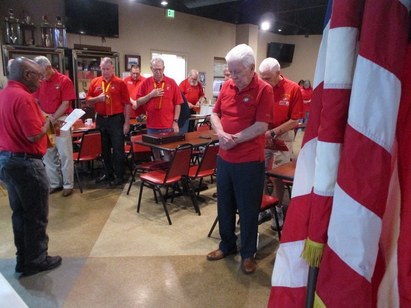 Group of seniors in red shirts meeting indoors
