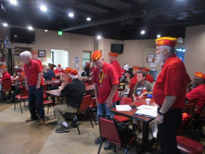 Group wearing red uniforms indoors gathering