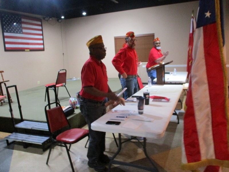 Members in red shirts at community meeting
