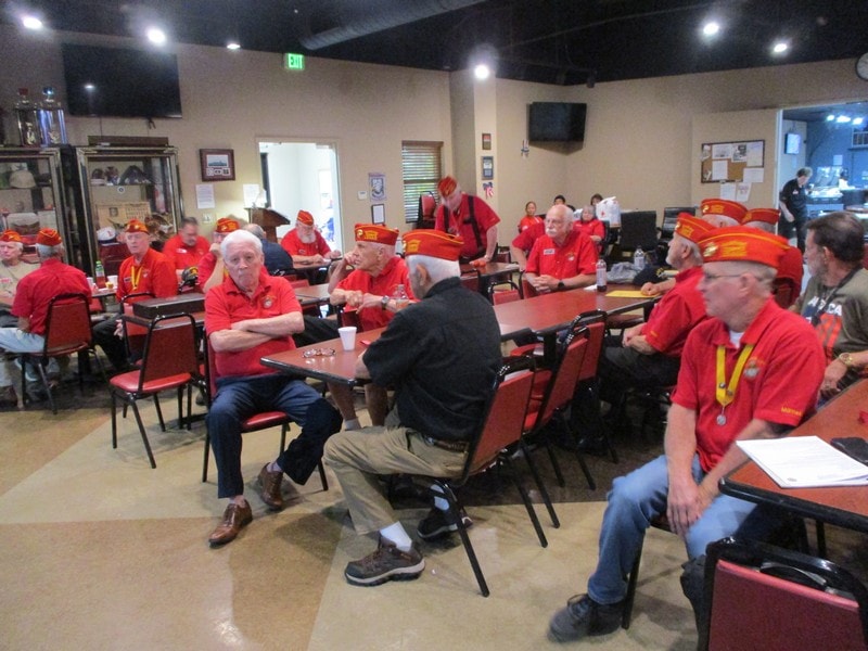 Group of volunteers in red shirts meeting indoors