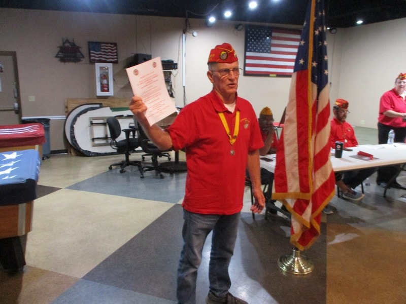 Veteran holding certificate at patriotic ceremony