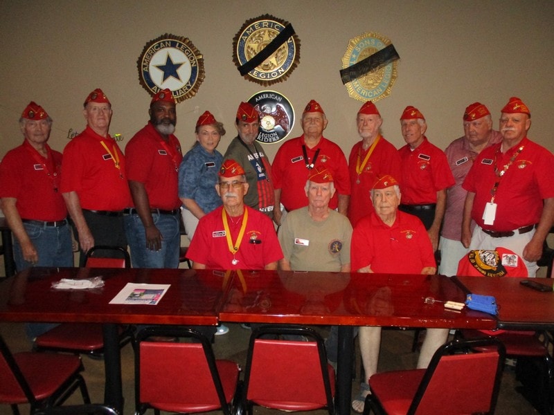 Veterans group photo with military insignia display
