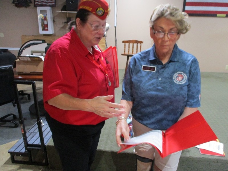 Two women reviewing document indoors
