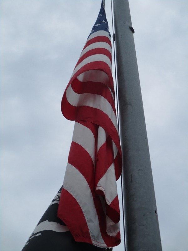 American flag waving on metal pole