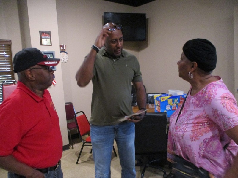 Three members conversing indoors