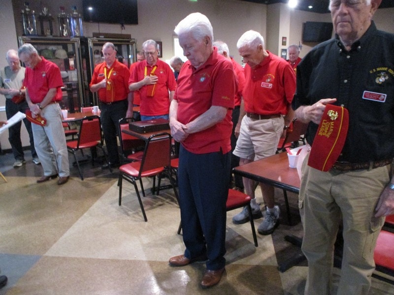 Senior veterans gathering in red uniforms indoors