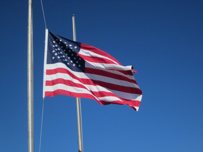 American flag waving against clear blue sky
