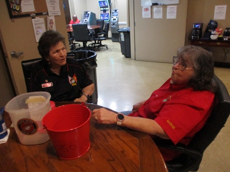 Two members conversing at meeting table