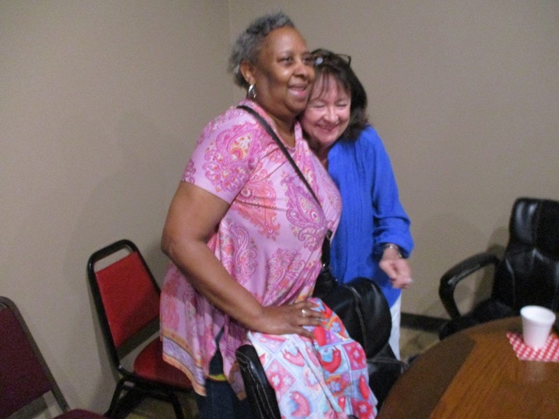 Two women smiling together indoors