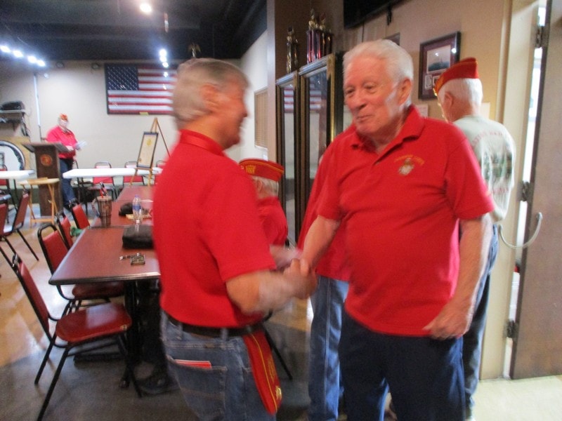 Two members shaking hands at community event