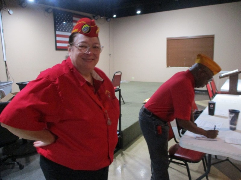 Member in red shirt wearing novelty headwear indoors
