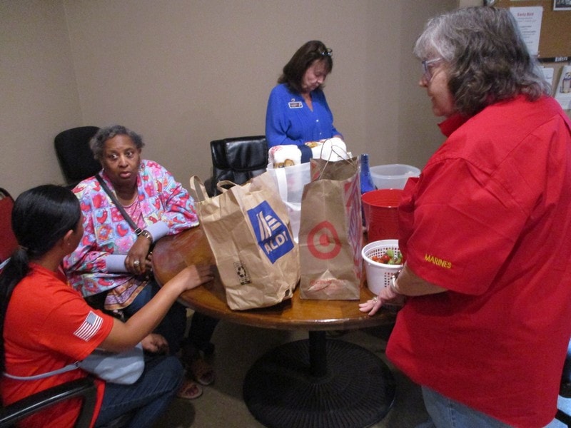 Volunteers distributing food donations indoors