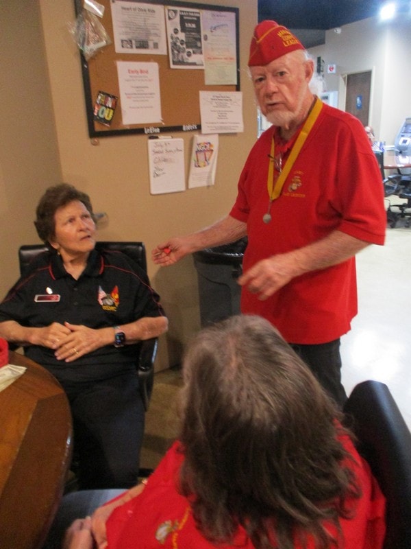 Senior member speaking to youth group indoors