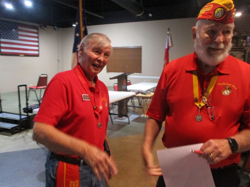 Veterans in red uniforms at meeting