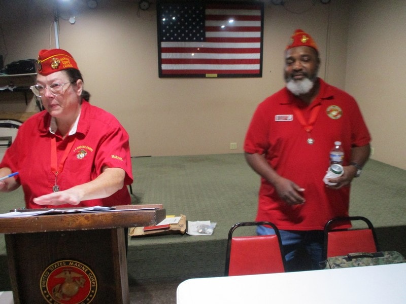 Marine veterans in red uniforms indoors