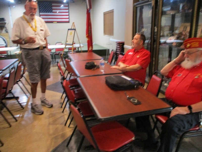 Member speaking to group at meeting table