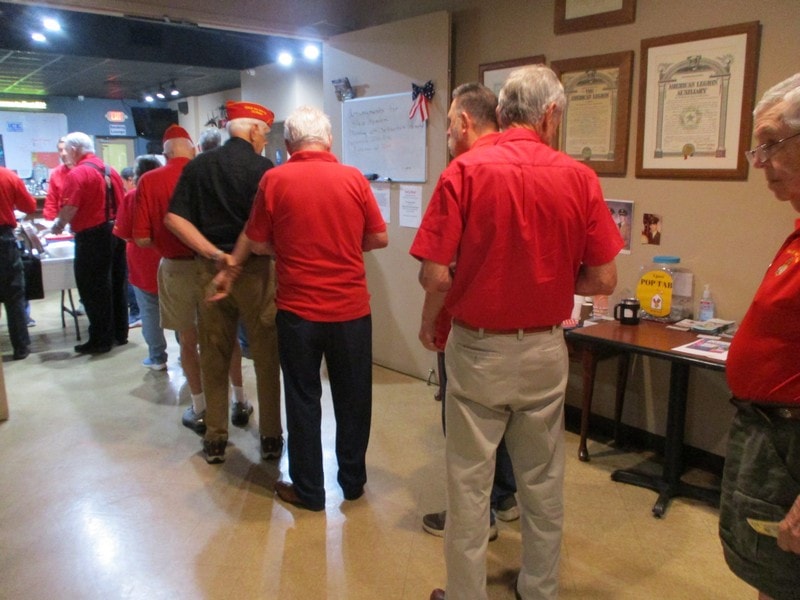 Senior veterans gathering in red shirts