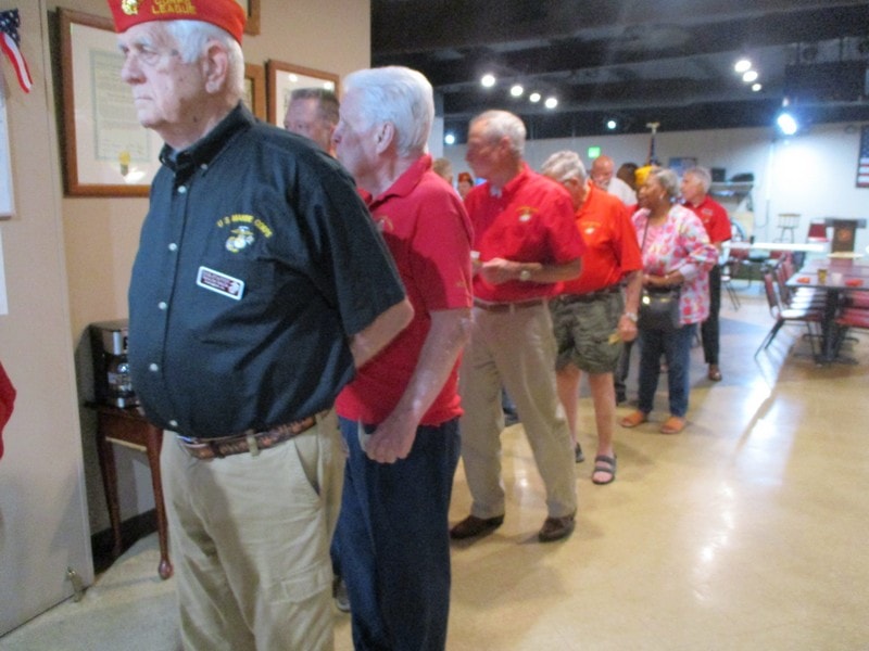 Veterans standing in line indoors