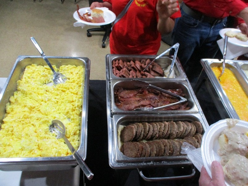 Buffet food trays with meat and sides