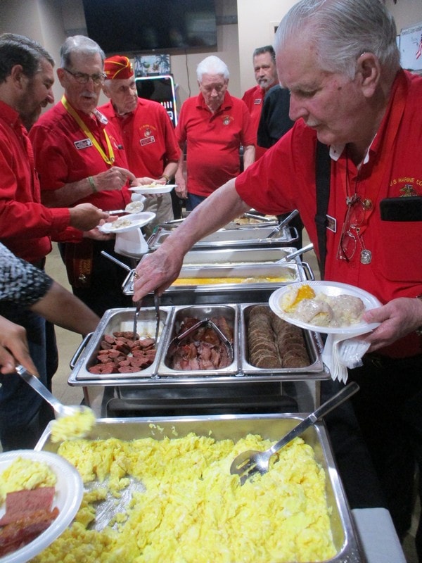 Volunteers serving breakfast buffet line